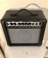 Front and control panel view displaying input, gain, volume, bass, middle, treble controls, output, headphone jack, and power switch. Shows Yamaha branding and GA-15 model.