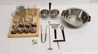 Full lot view showing whiskey glasses on tray, shell napkin holders, bar tools, condiment dishes
