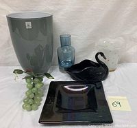 All items in the lot displayed together including the vases, swan figurine, iridescent dish, and glass grapes.