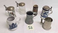 Overview of all six vintage beer steins including varied materials and styles