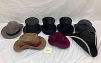 Overhead view of all eight hats on white background