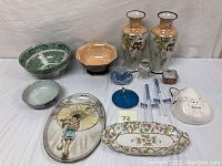 Overview of the collection including bowls, vases, tray, dish, chopsticks, face mask and trinket dishes