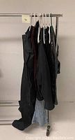 Six garments on rolling rack showing overall lot
