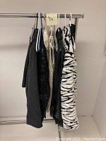Rack of assorted vintage women’s garments on hangers