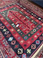 Overall view of 5'x8' Navajo style flatweave rug on display