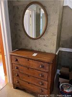 Full view of dresser with mirror mounted above