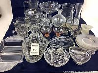 Full view of all over 20 vintage glassware pieces arranged including pitchers, bowls, mugs, serving trays, plates, and decorative glass items.