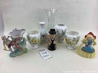 Eight assorted vintage vases and figurines in a group