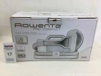 Front and side views of the Rowenta Pro Compact Garment Steamer IS1430 box showing product image and branding.