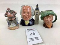Front view of the three Royal Doulton figurines showing detailed facial features and colors.