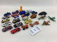 Overview of all 22 toy vehicles and figure showing variety and condition