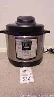 Full view of Instant Pot Lux Mini electric pressure cooker on carpeted floor with catalog tag 552
