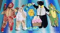 All six kids Halloween costumes laid flat showing overall condition and color.