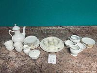 Lot of misc fine china and glassware items including Royal Copenhagen plates, cups, teapot, sugar dish, creamer; Wedgwood Peter Rabbit set; Wassel china pieces; glass dessert dishes.