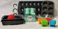 Photo showing all assorted bakeware items including pie plates, cupcake trays, cake pans, ice pop cones and robot cupcake molds