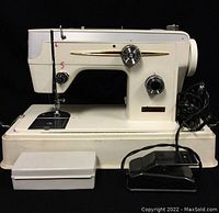 Front view of Baycrest sewing machine with foot pedal and accessories arranged in front.