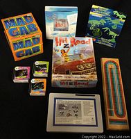 Overview photo showing all board games and puzzles included in the lot arranged on a flat surface.