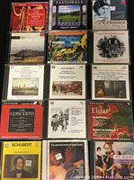 Photo showing an assortment of 14 classical music CDs with titles including Schubert, Beethoven, Brahms, Elgar, Balakirev, and others, arranged in three rows.