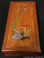 Top view of the wooden box showing the hand-painted fairy and mushroom scene on the lid.