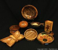 Photo of seven unique hand carved and painted wooden bowls and dishes from Mexico, showing differing sizes and colorful designs.