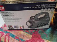 Photo of the Campbell Hausfeld home inflation system box showing product image and features in English and French.