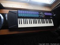 Full view of Yamaha PSR-77 keyboard showing keys, control panel, and speaker on left side.