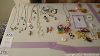 Full table layout showing necklaces, earrings, bracelets, rings and brooches
