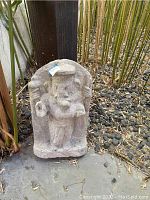 Front view of a carved stone statue depicting an elephant-headed figure standing upright.