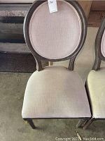 Front view of Restoration Hardware dining chair showcasing oval backrest and fabric seat