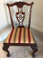 Full front view showing chair back, upholstered seat with striped fabric, and detailed front legs with ball and claw design.