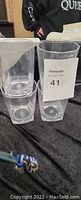 Four clear plastic heavy duty drinking cups stacked in pairs.