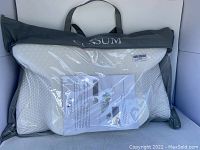 Coisum branded gray bag containing white memory foam cervical pillow with visible packaging and informational insert