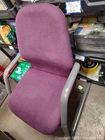 Top front view of one purple office chair showing fabric seat and curved back with metal armrests and base.
