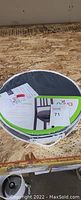 Top-down photo of the Nova padded swivel seat cushion in its packaging, showing product information and branding.