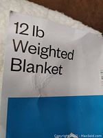 Close-up photo of the label showing '12 lb Weighted Blanket' text