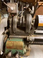 Headstock assembly showing belt drive, feed levers and control handle