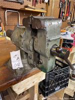 Side and front view of Allied multi-purpose bench vise mounted on a bench, showing handle and jaws with wear and surface rust.