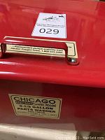 Close-up of the front label on the parts washer also showing a pickup label and replacement pump info.