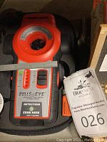 Black & Decker Bulls Eye stud, metal, and AC wire detector device placed inside a black molded foam case, showing its controls and laser level sensor area