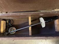 Torque wrench with dial indicator in a wooden box