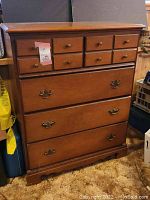 Full front view of the wooden dresser showing all drawers closed