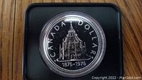Obverse side of the 1976 Canadian silver dollar showing the Library of Parliament engraving dated 1876-1976.