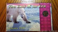 Collector card with polar bear image and title 'The End of An Era', marking new coin replacement of banknote, dated 1996 Canada.