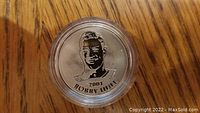 Close-up of 2001 Bobby Hull medallion featuring engraved portrait and inscription in protective case.