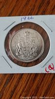 Reverse side of the coin showing the Canadian coat of arms and the year 1966.