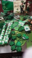 Wide view of assorted St. Patrick's Day decorations including wrapping paper, shamrocks, banners, and figurines.