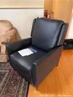 Recliner angled view with paperwork on the seat