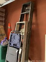 Photo showing the overall lot with step stool in front and two tall metal ladders (6-foot and 8-foot) leaning against the wall.