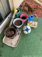 Garden pots, watering cans, soccer ball, pastel balls container and metal tray