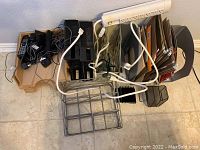 Top view of lot showing telephones, file folders, file holders, power strip, and organizers on tiled floor